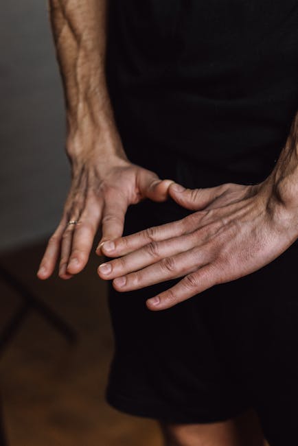 Close-up of a person's hands in a mudra pose during meditation